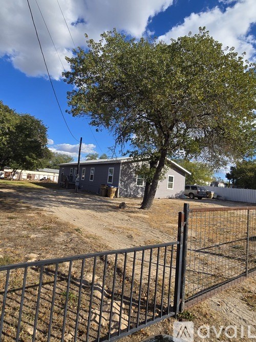 A house with a tree in front of it.