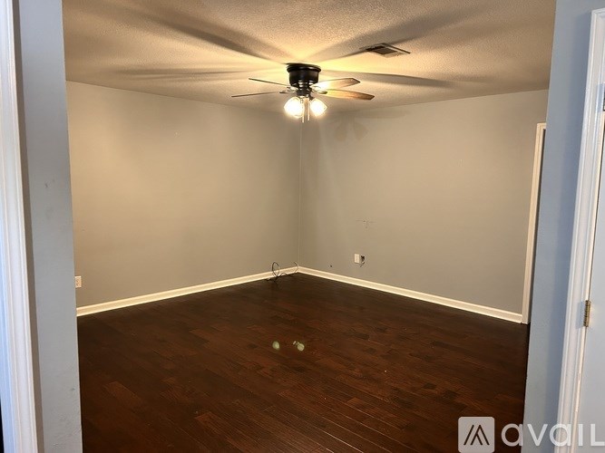 A room with a ceiling fan and lights.