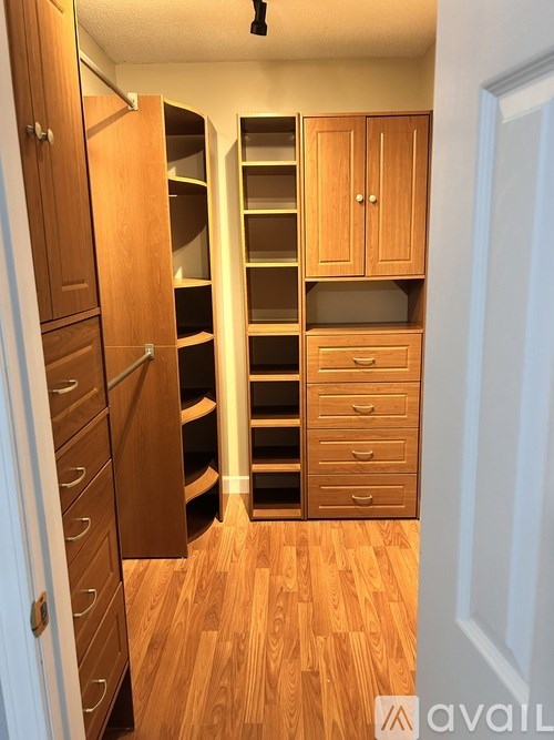 A room with wooden floors and cabinets.