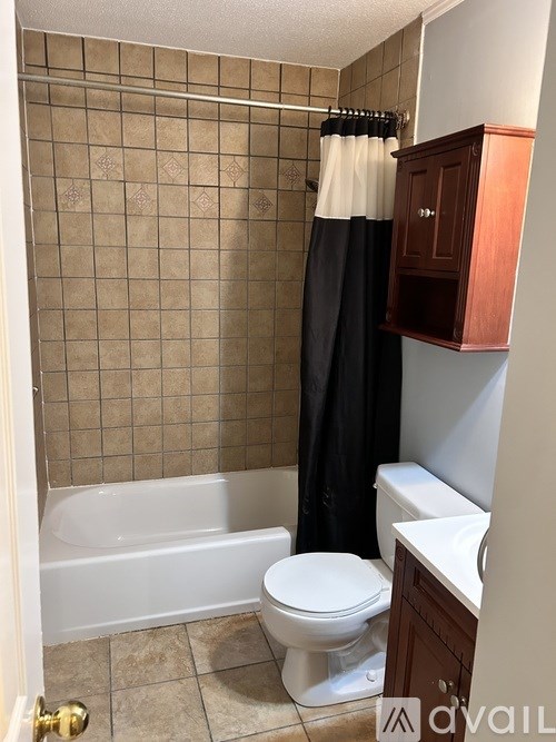 A bathroom with a toilet, tub, and sink.