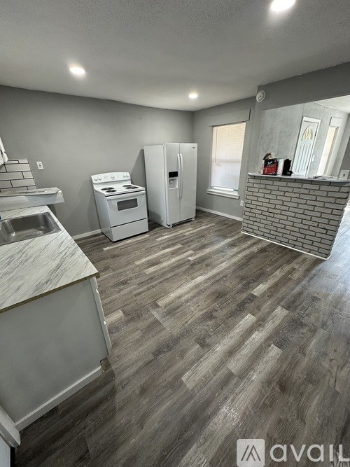 A kitchen with a white fridge and a white oven.