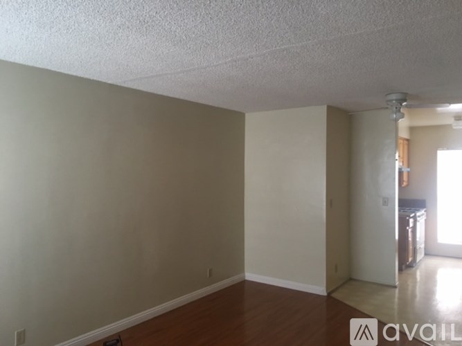 A room with beige walls and a wooden floor.