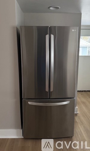 A stainless steel fridge with a handle on the door and a handle on the freezer door.