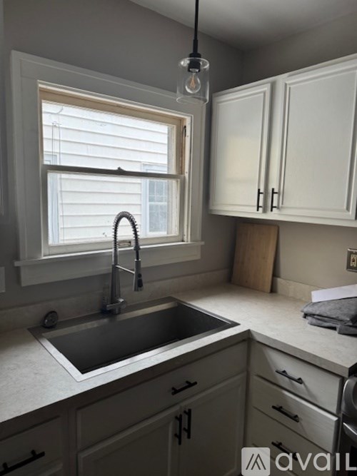 A kitchen with a sink under a window.