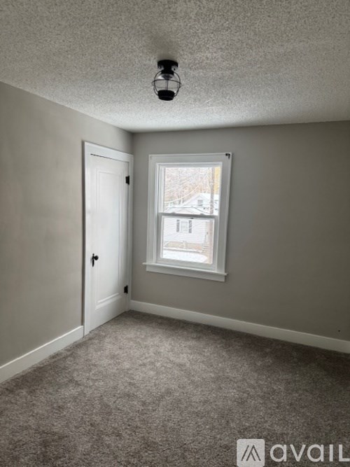 A room with a window and a door.