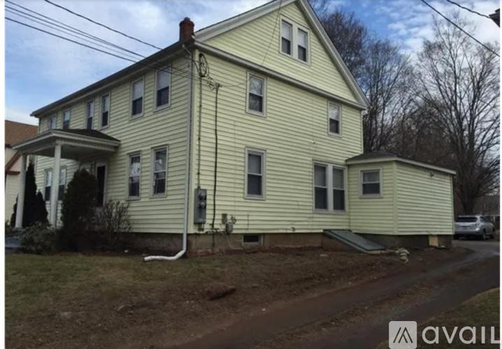 A two-story house with a white siding exterior.