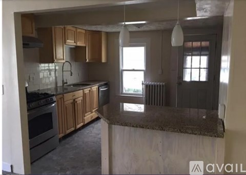 A kitchen with wooden cabinets and a granite countertop.