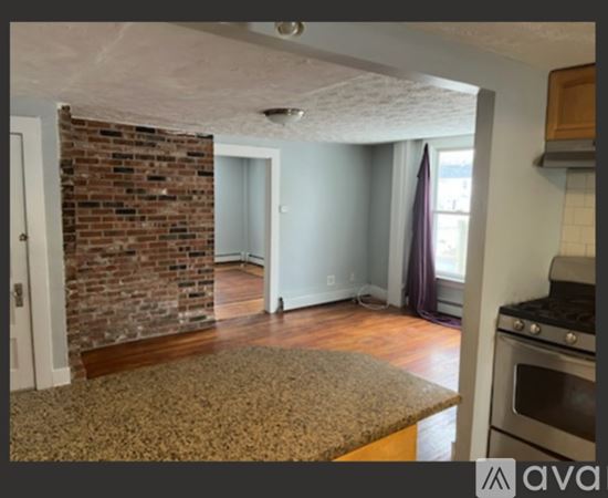 A kitchen with wooden cabinets and a granite countertop.