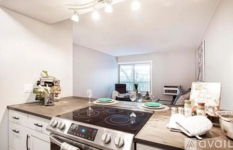 A kitchen with a stove top oven and a window.