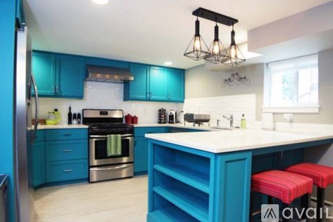 A kitchen with blue cabinets and a white island.