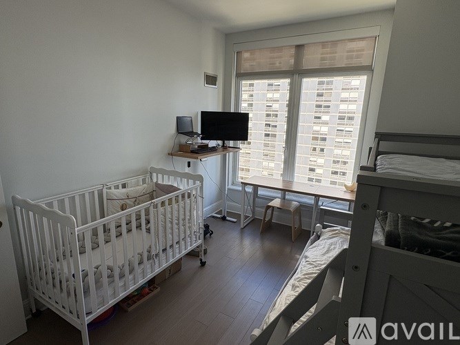A baby room with a crib and a bed.