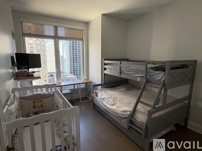 A baby's room with a crib and a bunk bed.