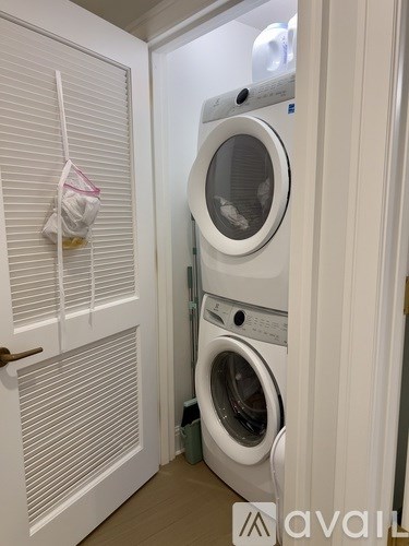 A white washing machine and dryer in a small laundry room.