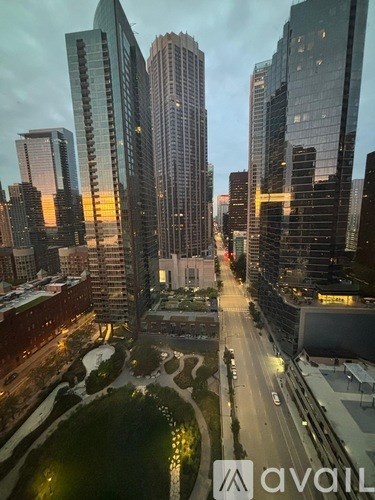 A cityscape with tall buildings and a river running through it.