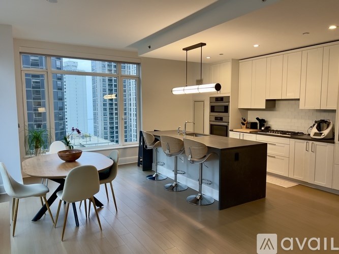 A modern kitchen with white cabinets and a large island.