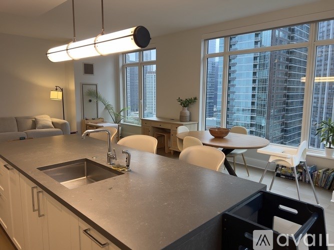 A modern kitchen with a large island and a view of the city.
