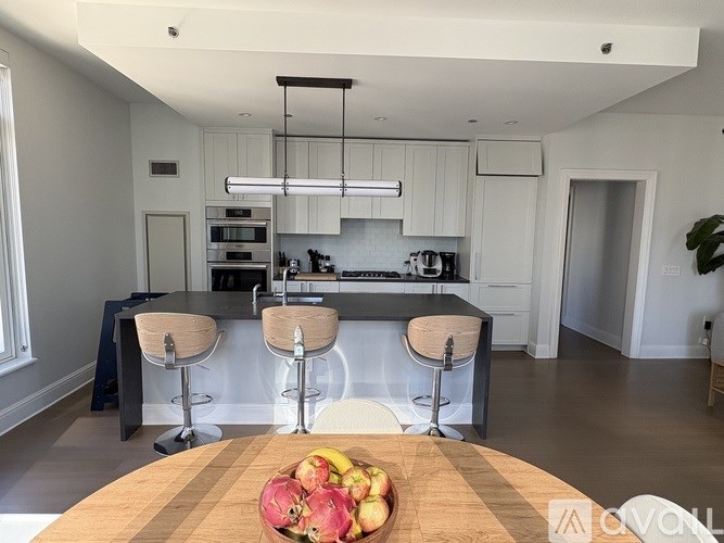 A kitchen with a wooden table in front of it.