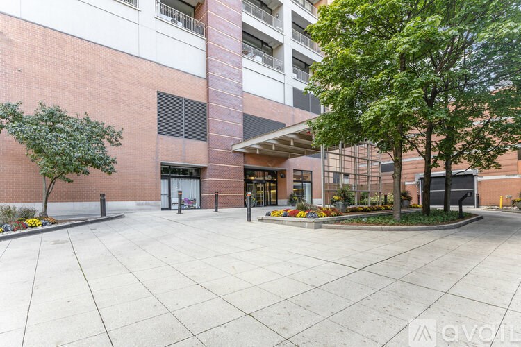 A brick building with a tree in front.