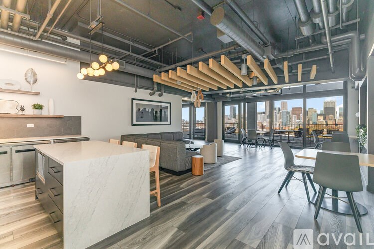 A modern kitchen with a large island and a view of the city.