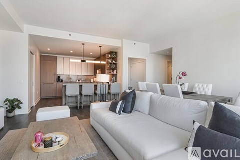 A modern living room with a white sofa and a wooden coffee table.