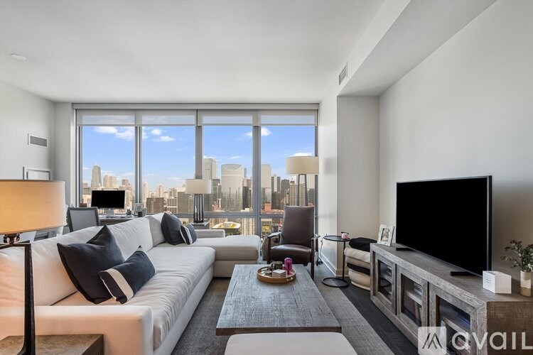 A modern living room with a large window overlooking the city.