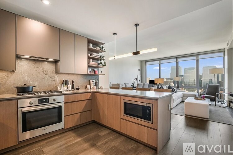 A modern kitchen with wooden cabinets and stainless steel appliances.