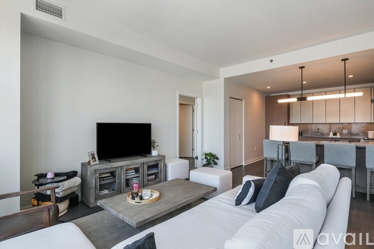 A modern living room with a white sofa and a wooden coffee table.