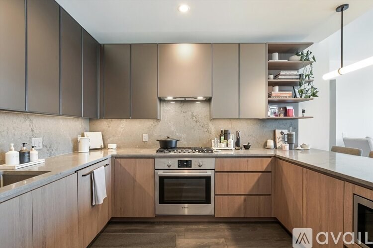 A modern kitchen with wooden cabinets and a stainless steel stove.