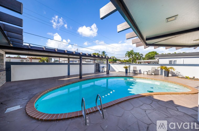 A swimming pool with a sunny sky in the background.
