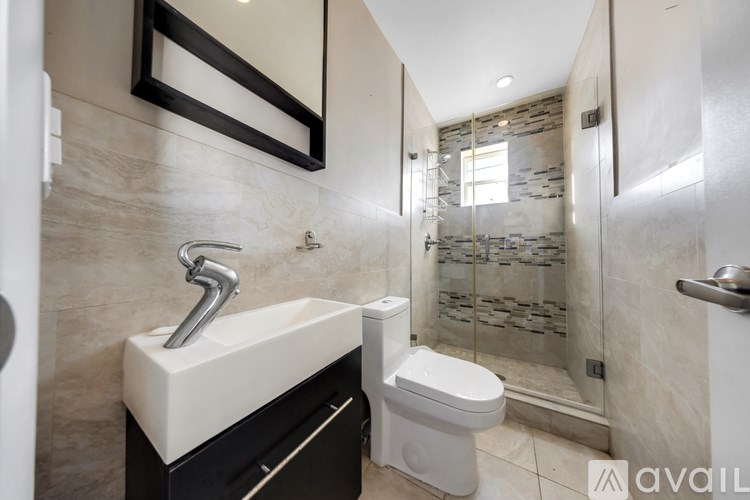 A bathroom with a sink, toilet and shower.