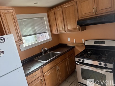 A kitchen with wooden cabinets and a white fridge.