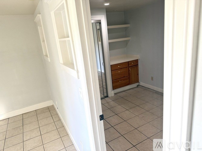 A bathroom with a white sink and a window with blinds.
