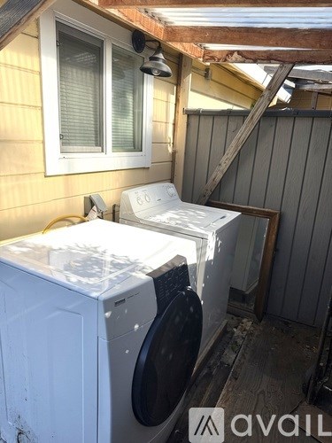 A bathroom with a toilet, sink, and mirror.