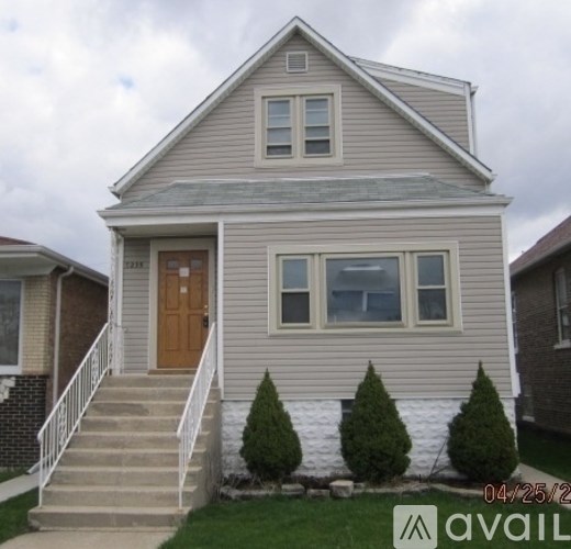 A house with a brown door and a small porch.