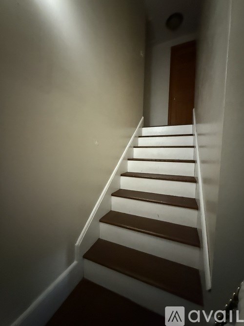 A staircase with white and brown steps.