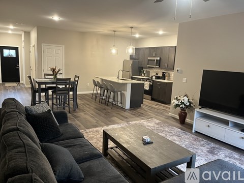 A modern living room with a grey sofa and a wooden coffee table.
