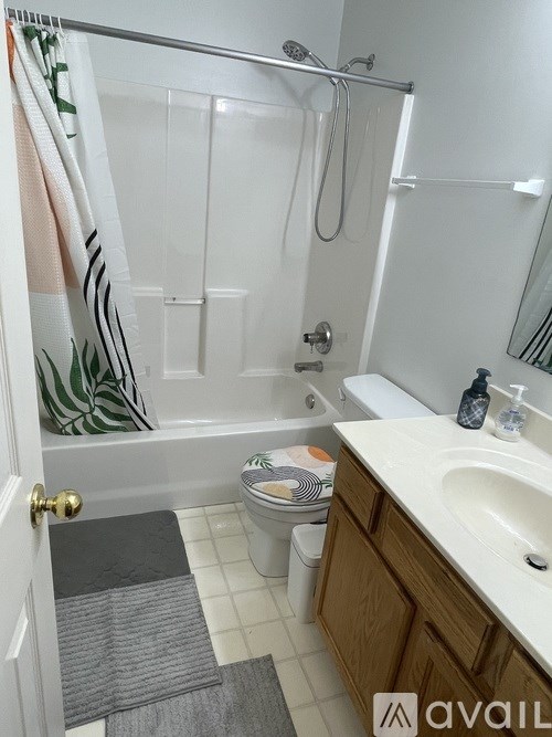 A bathroom with a toilet, sink, and shower.