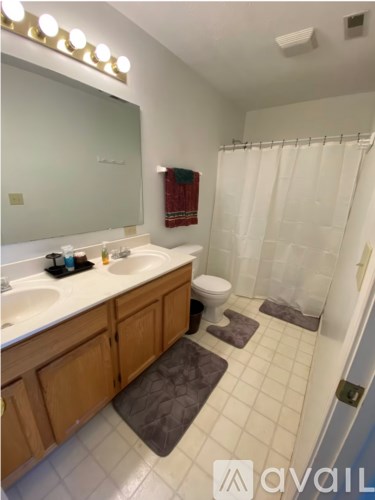 A bathroom with a white sink and a white toilet.