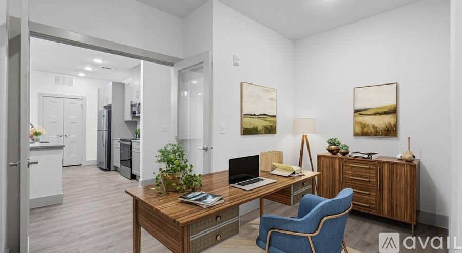 A modern kitchen with a dining table and chairs in the foreground.