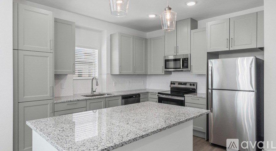 A kitchen with granite countertops and stainless steel appliances.