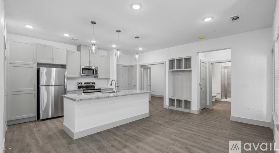 A modern kitchen with stainless steel appliances and a central island.
