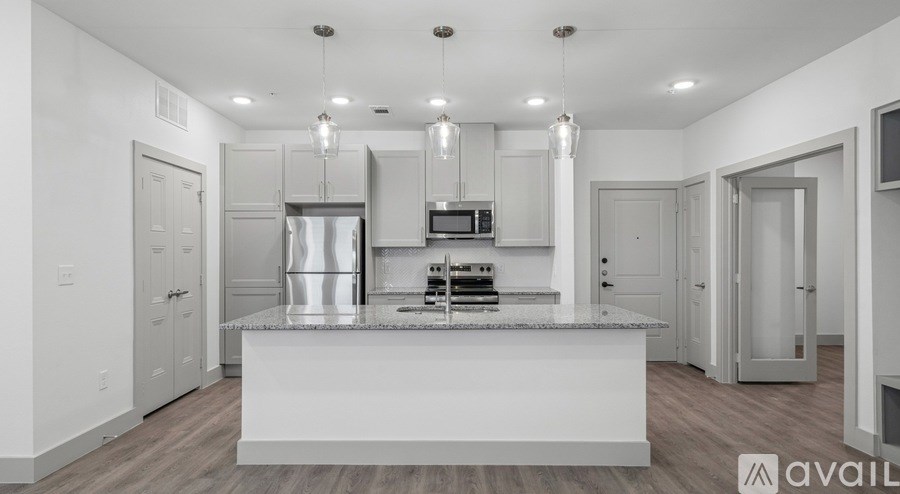 A modern kitchen with a large island in the center.