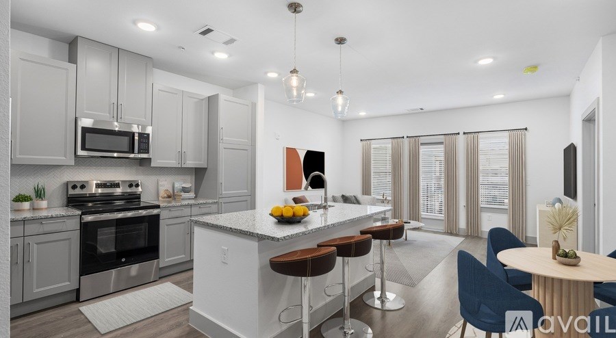 A modern kitchen with a bar stool and a dining table.