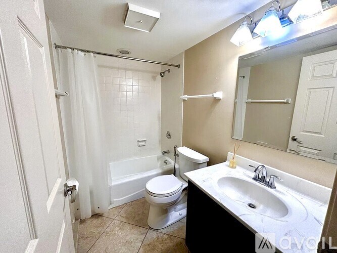 A bathroom with a toilet, sink, and bathtub.