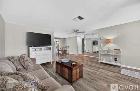 A living room with a couch, a television, and a coffee table.