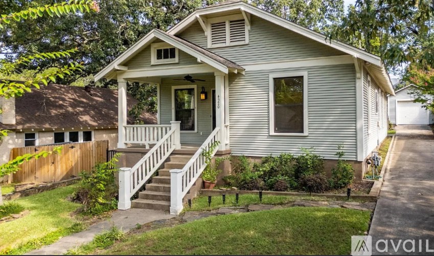 A house with a front porch and a small front yard.