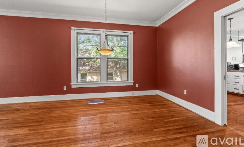 A room with red walls and a wooden floor.