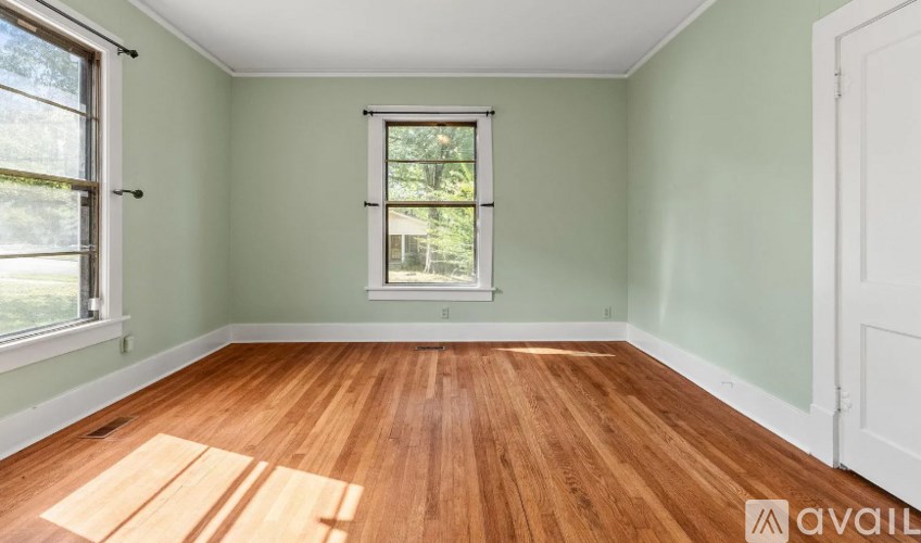 A room with wooden floors and a window.