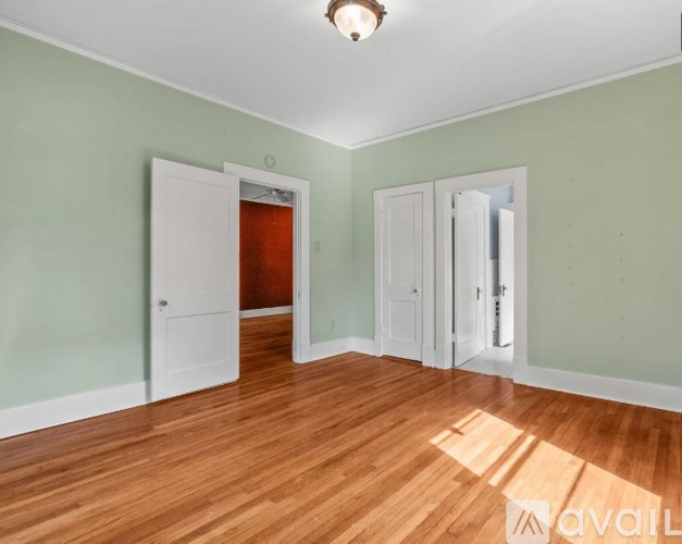 A room with wooden floors and green walls.