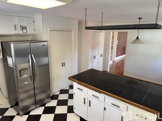 A kitchen with a black and white checkered floor.